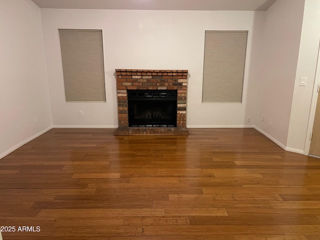 unfurnished living room with a fireplace and wood-type flooring