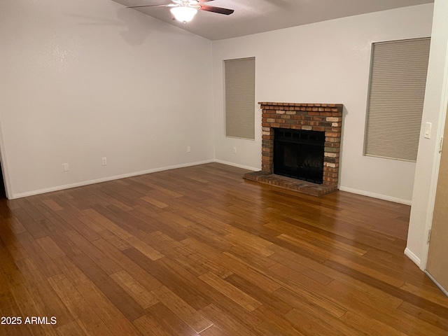 unfurnished living room with ceiling fan, dark hardwood / wood-style floors, and a fireplace