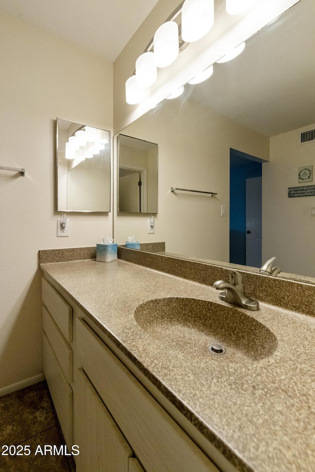 bathroom featuring tile patterned flooring and vanity