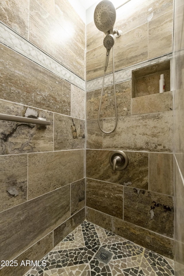 bathroom with tiled shower