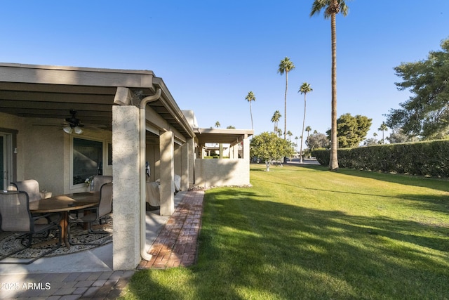 view of yard with ceiling fan