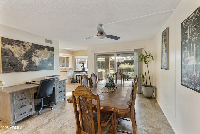 dining room featuring ceiling fan, light tile patterned flooring, and a textured ceiling