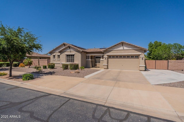 craftsman inspired home featuring fence, stucco siding, roof mounted solar panels, an attached garage, and driveway