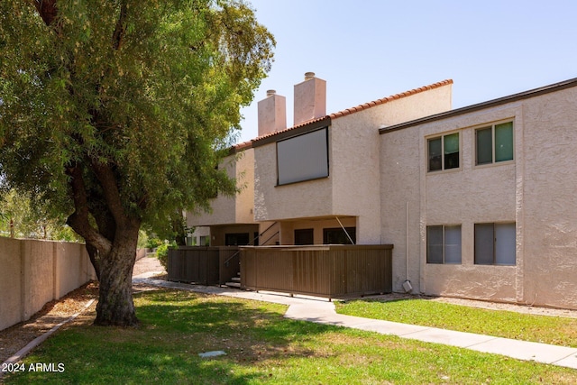 rear view of house featuring a lawn