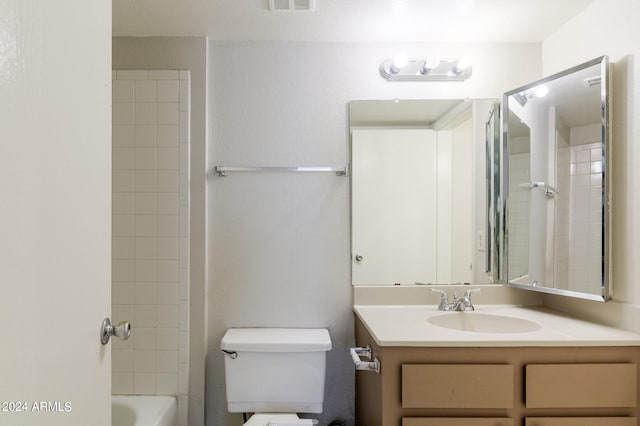 full bathroom with vanity, toilet, and tiled shower / bath combo