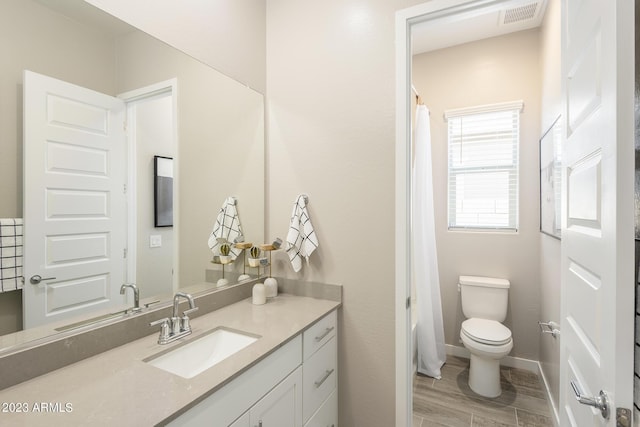 bathroom with hardwood / wood-style flooring, vanity, toilet, and a shower with shower curtain