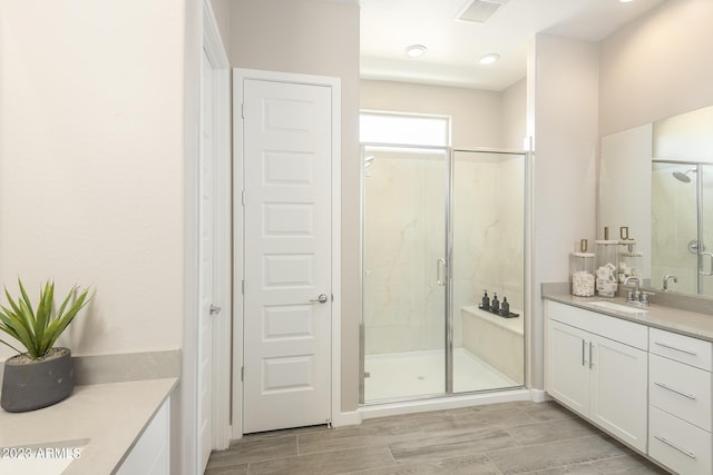 bathroom featuring vanity and an enclosed shower