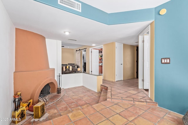 9012 S 47th Pl, Phoenix, AZ 85044 - unfurnished living room featuring visible vents and a barn door