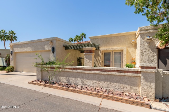 9012 S 47th Pl, Phoenix, AZ 85044 - pueblo revival-style home with stucco siding, driveway, and a garage