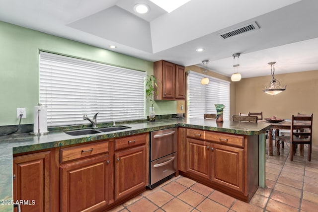 9012 S 47th Pl, Phoenix, AZ 85044 - kitchen featuring a sink, brown cabinetry, dishwasher, a peninsula, and visible vents