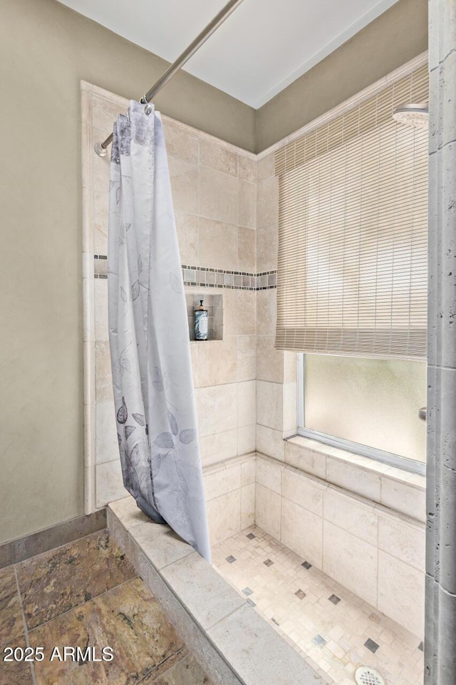 9012 S 47th Pl, Phoenix, AZ 85044 - bathroom featuring a tile shower and stone finish flooring