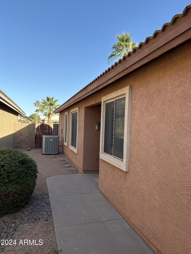 view of home's exterior with cooling unit and a patio