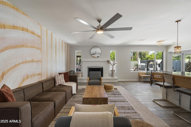 4904 E Tierra Buena Ln, Scottsdale, AZ 85254 - living room featuring plenty of natural light, a brick fireplace, wood finished floors, and ceiling fan