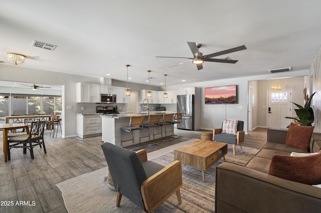 4904 E Tierra Buena Ln, Scottsdale, AZ 85254 - living room with visible vents, baseboards, wood finished floors, and ceiling fan