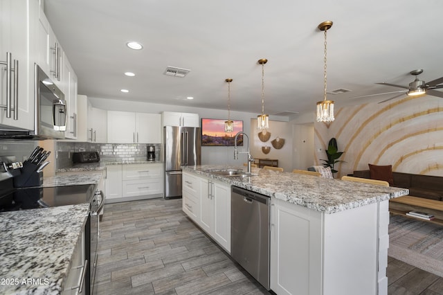4904 E Tierra Buena Ln, Scottsdale, AZ 85254 - kitchen with ceiling fan, visible vents, appliances with stainless steel finishes, a sink, and backsplash