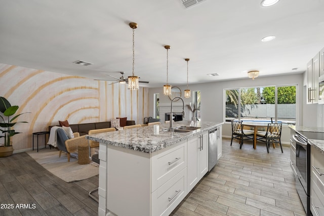 4904 E Tierra Buena Ln, Scottsdale, AZ 85254 - kitchen featuring a sink, wood finish floors, appliances with stainless steel finishes, and a chandelier