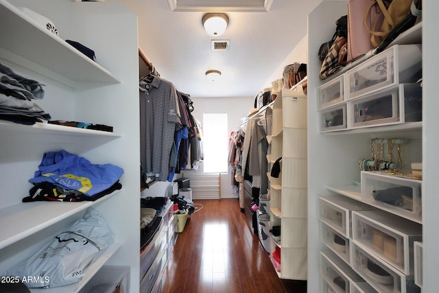 walk in closet featuring dark wood-type flooring