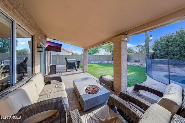 view of patio / terrace featuring area for grilling and an outdoor living space with a fire pit