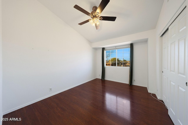 unfurnished bedroom featuring ceiling fan, a closet, lofted ceiling, and dark hardwood / wood-style flooring