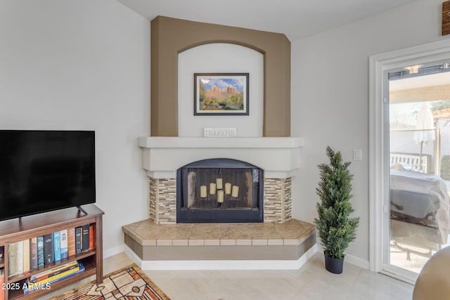 tiled living room with a tiled fireplace