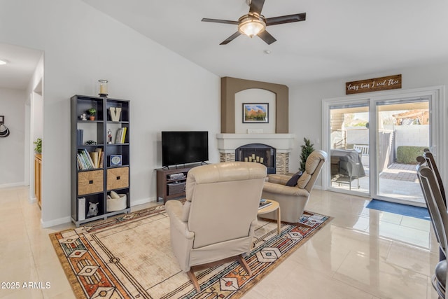 tiled living room featuring ceiling fan and vaulted ceiling