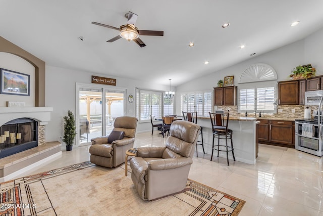 tiled living room featuring vaulted ceiling and ceiling fan