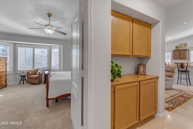 hallway featuring plenty of natural light and light carpet