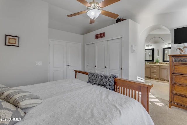 carpeted bedroom with connected bathroom, a closet, and ceiling fan