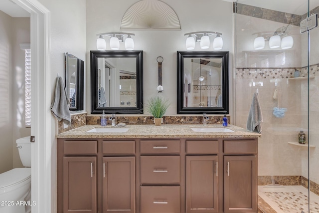 bathroom featuring an enclosed shower, vanity, and toilet