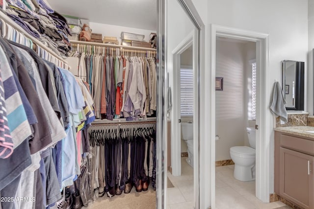 spacious closet featuring light tile patterned flooring