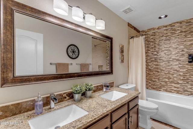 full bathroom featuring shower / tub combo, vanity, and toilet