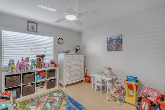 game room with light carpet and ceiling fan