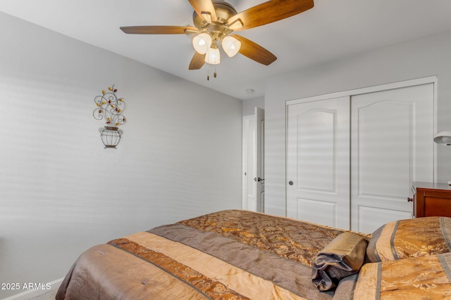 bedroom featuring ceiling fan and a closet