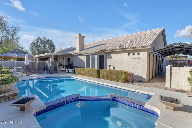 view of swimming pool featuring an in ground hot tub, a gazebo, and a patio