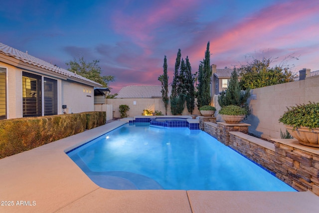 view of pool at dusk