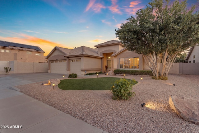 view of front of home featuring a garage and a yard