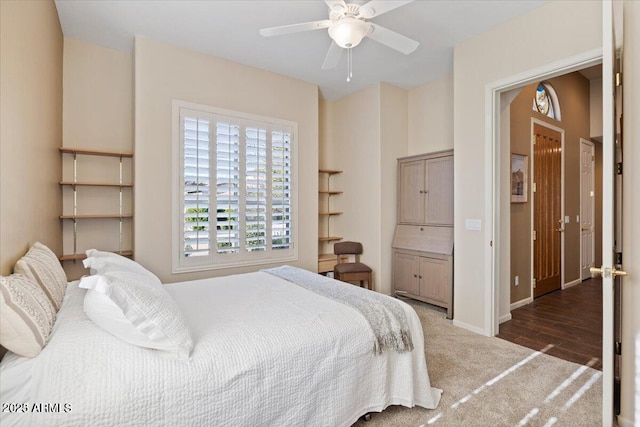 bedroom with ceiling fan and dark hardwood / wood-style flooring