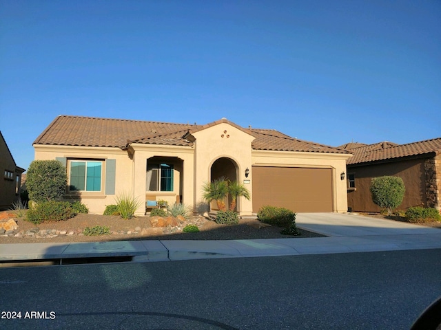 mediterranean / spanish-style home with a garage