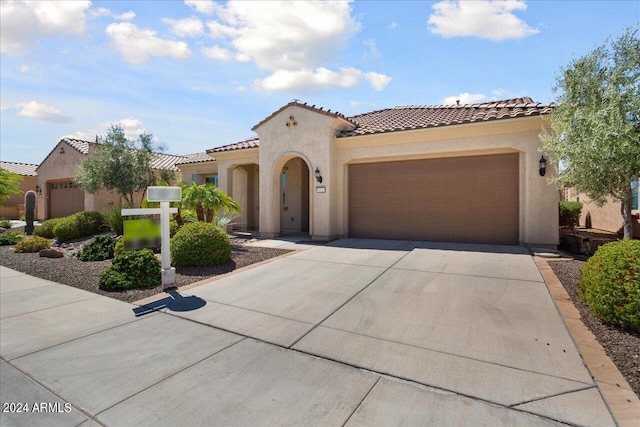 mediterranean / spanish home with a garage