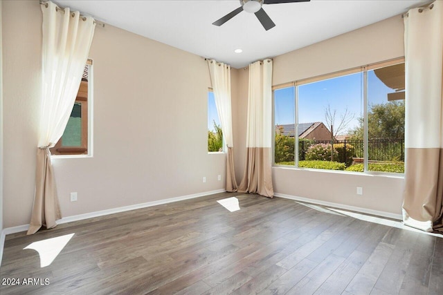 spare room featuring ceiling fan, plenty of natural light, and hardwood / wood-style floors