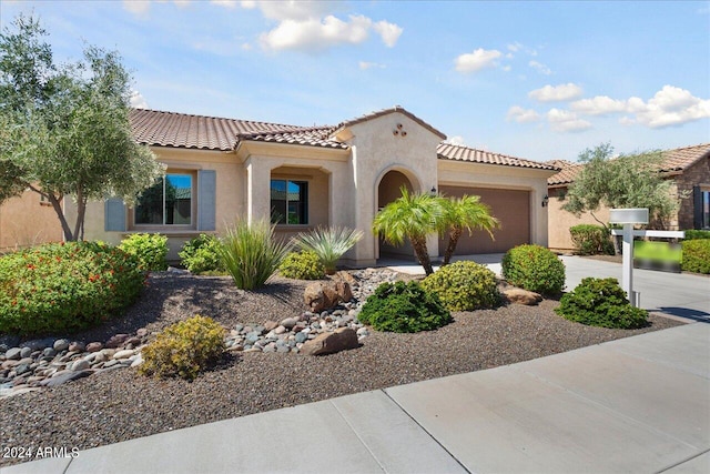 mediterranean / spanish-style home featuring a garage