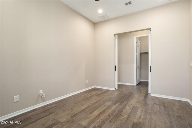 unfurnished room with dark hardwood / wood-style flooring