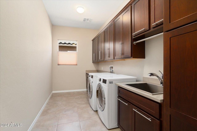 washroom featuring cabinets, independent washer and dryer, light tile patterned floors, and sink