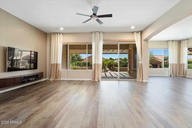 unfurnished living room with hardwood / wood-style floors and ceiling fan