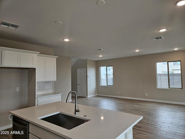 3390 S 180th Ln, Goodyear, AZ 85338 - kitchen with a sink, light wood-type flooring, open floor plan, light countertops, and recessed lighting