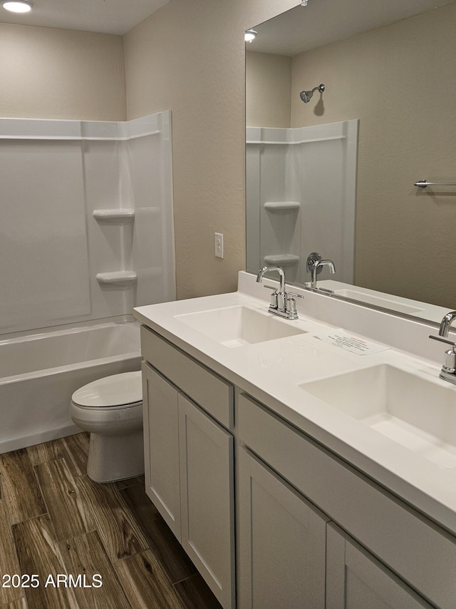 3390 S 180th Ln, Goodyear, AZ 85338 - bathroom featuring toilet,  shower combination, double vanity, and wood finished floors