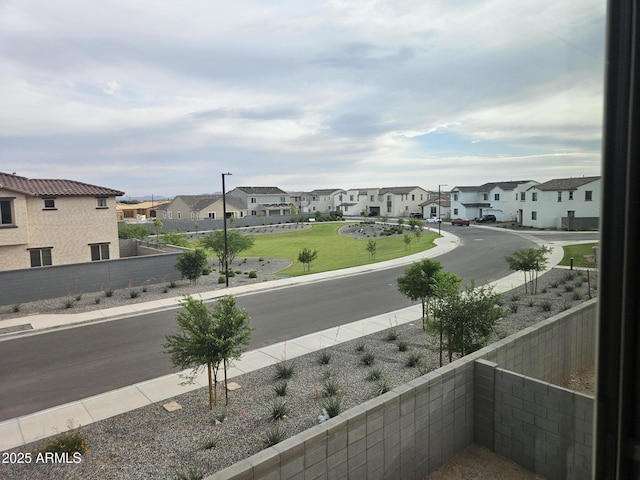 3390 S 180th Ln, Goodyear, AZ 85338 - view of asphalt road with a residential view, sidewalks, curbs, and street lighting