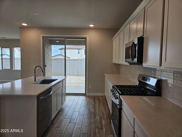 3390 S 180th Ln, Goodyear, AZ 85338 - kitchen with stainless steel appliances, a sink, healthy amount of natural light, dark wood-type flooring, and recessed lighting