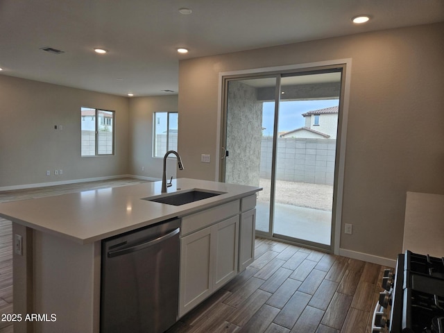 3390 S 180th Ln, Goodyear, AZ 85338 - kitchen featuring stainless steel appliances, a sink, wood finished floors, white cabinets, and recessed lighting