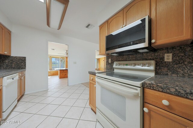 kitchen featuring white appliances, light tile patterned floors, baseboards, visible vents, and backsplash